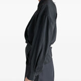 Black shirt worn by a person, showing the shirt's fit