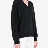 Black hoodie worn by a person, showing the hoodie fit