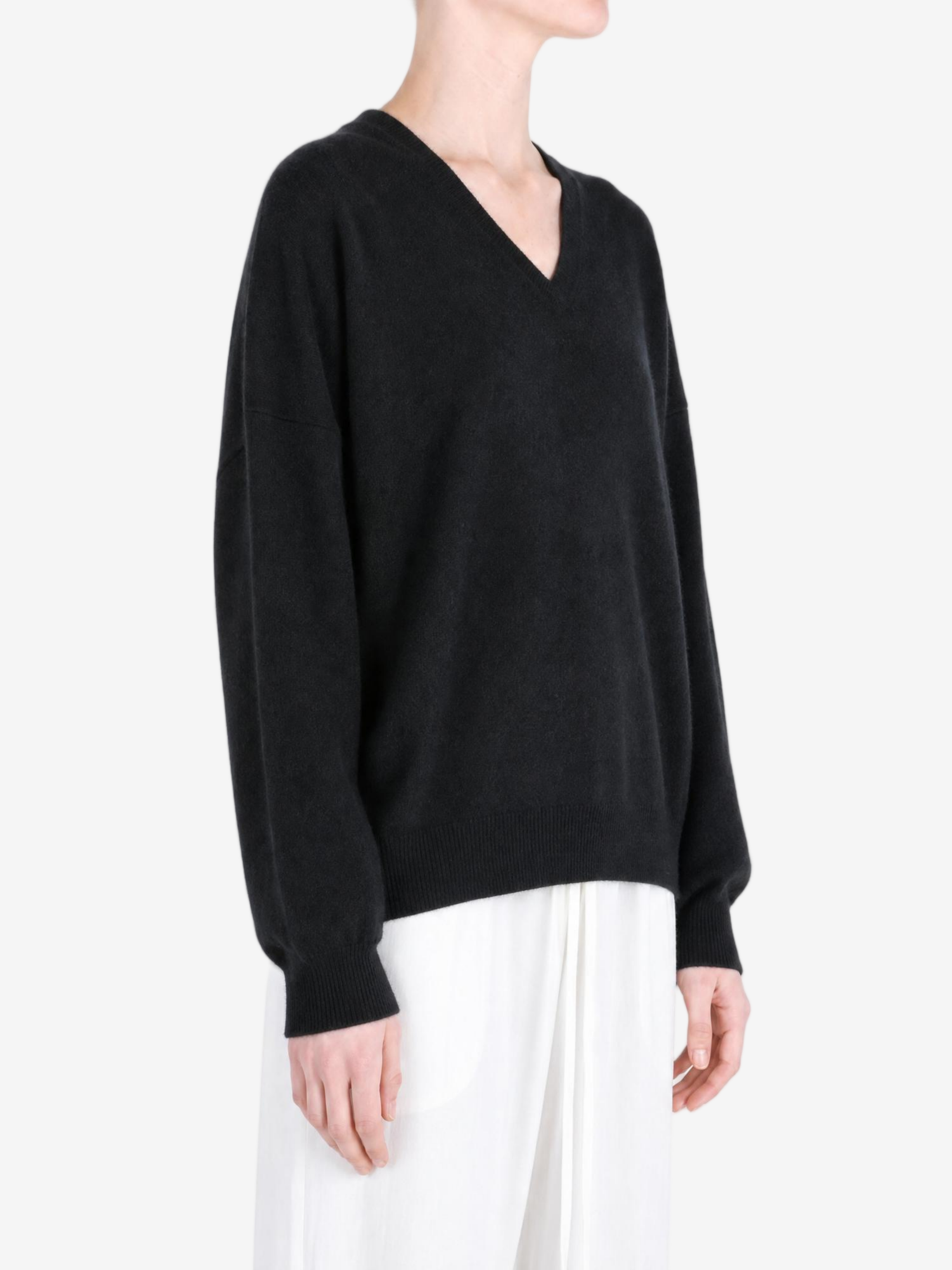 Black hoodie worn by a person, showing the hoodie fit