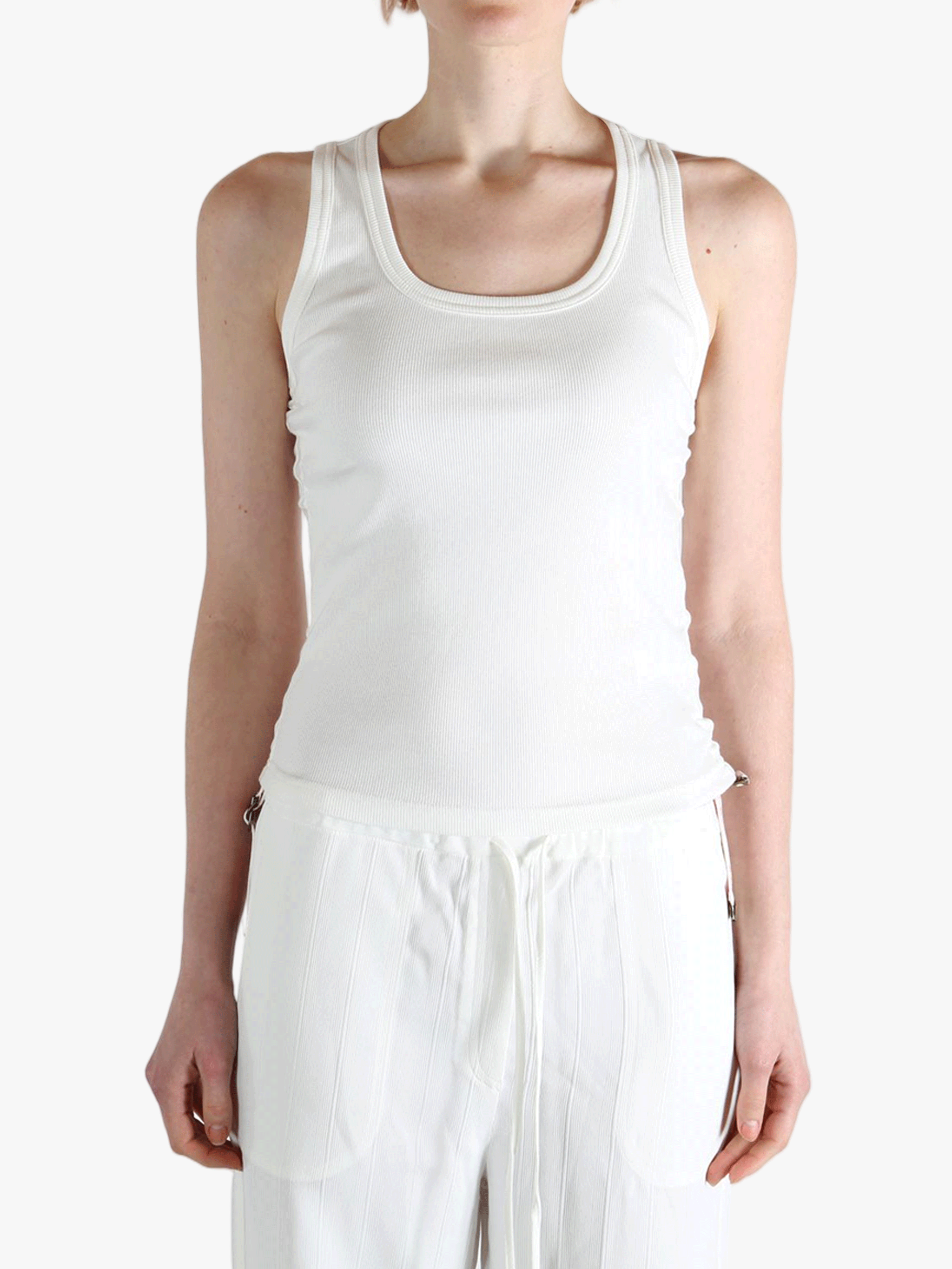 White top worn by a person, showing the top's fit