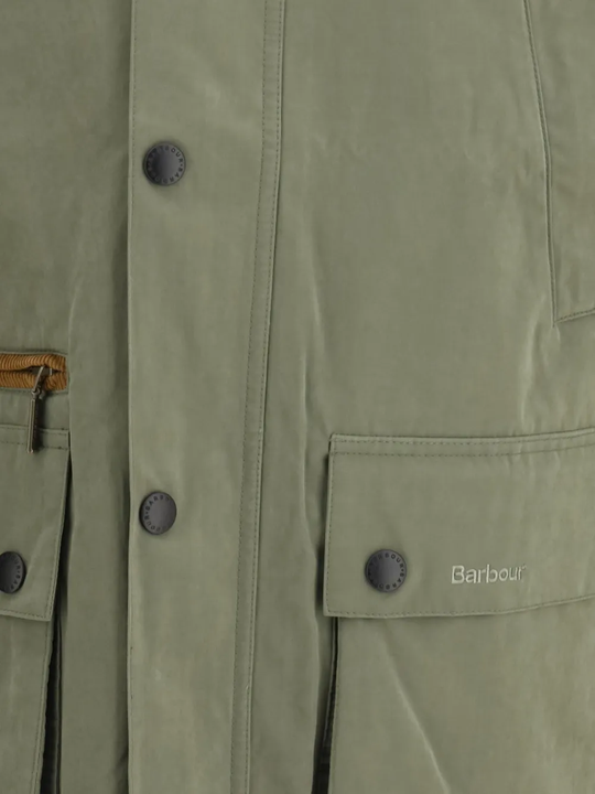 Close up of green jacket, showing texture of the cotton fabric