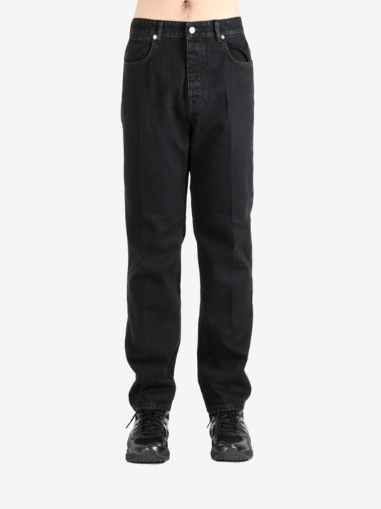 Black pants worn by a person, showing the pants's fit