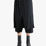 Black pants worn by a person, showing the pants' fit