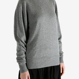 Grey knitwear worn by a person, showing the knitwear fit