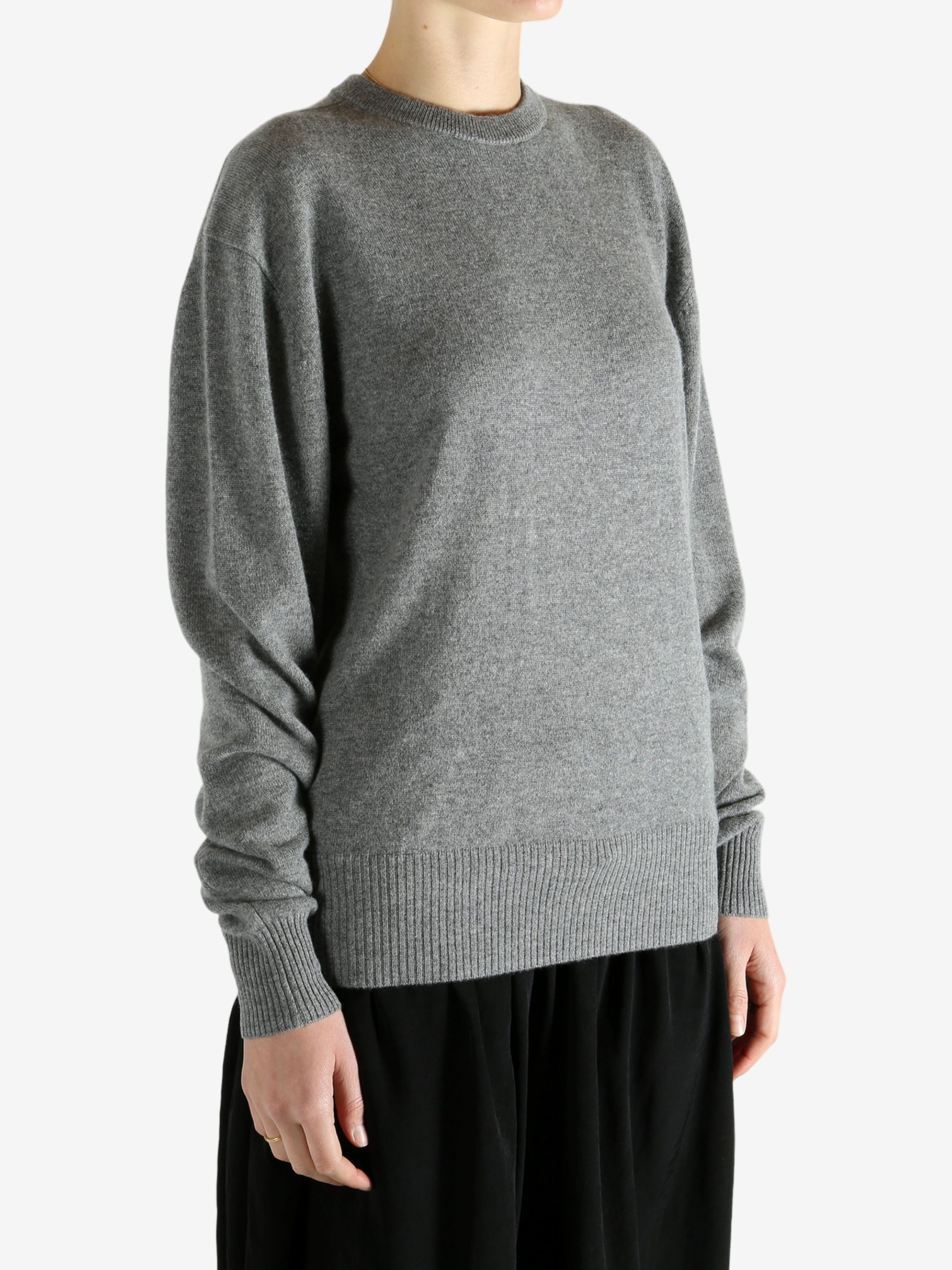 Grey knitwear worn by a person, showing the knitwear fit