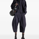 Navy pants worn by a person, showing the pants's fit