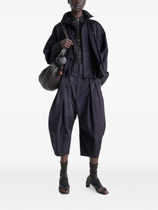 Navy pants worn by a person, showing the pants's fit