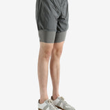 Grey shorts worn by a person, showing the shorts fit
