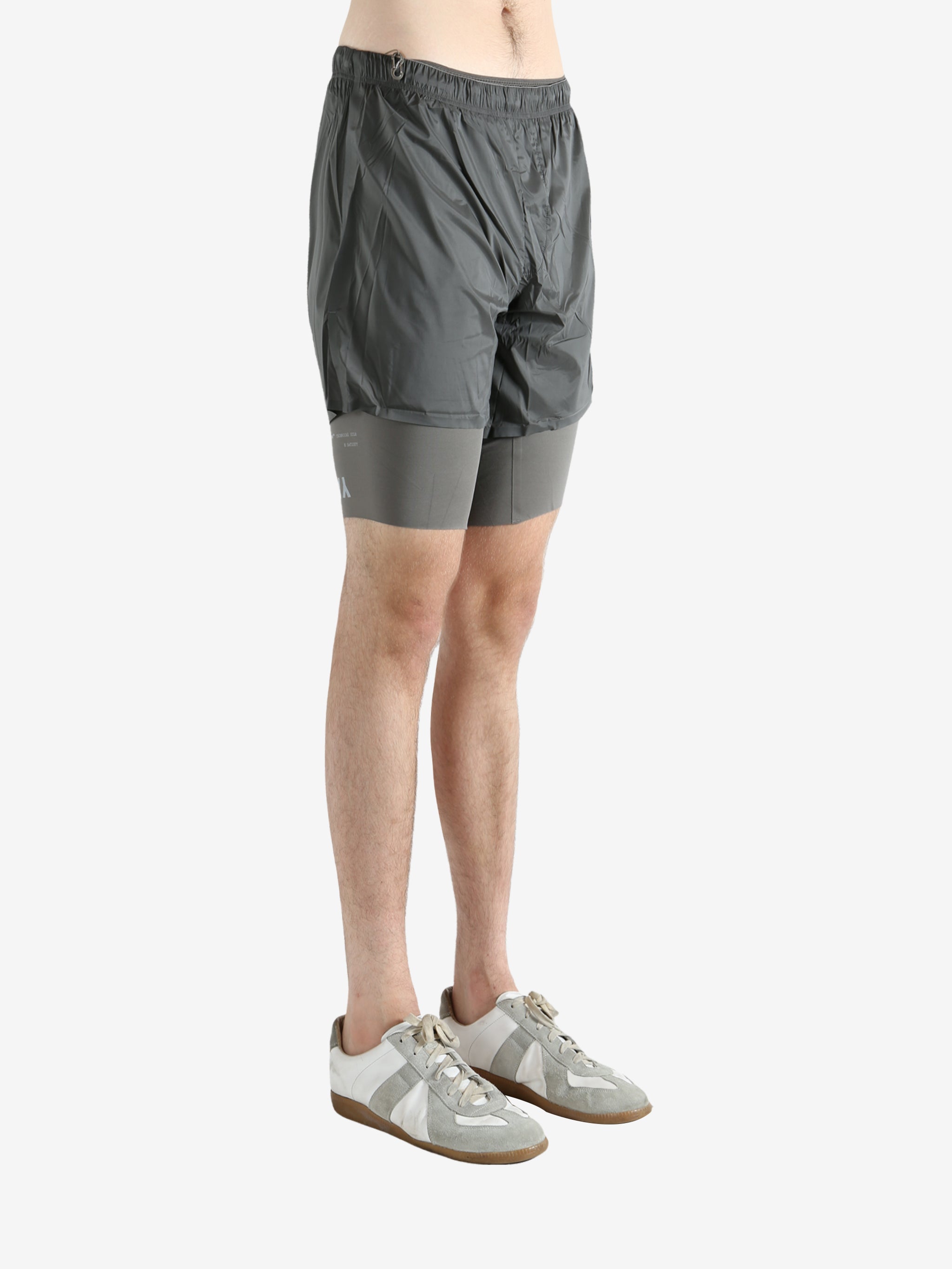 Grey shorts worn by a person, showing the shorts fit