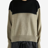 Black knitwear worn by a person, showing the knitwear fit