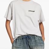 White t-shirt worn by a person, showing the cotton fit