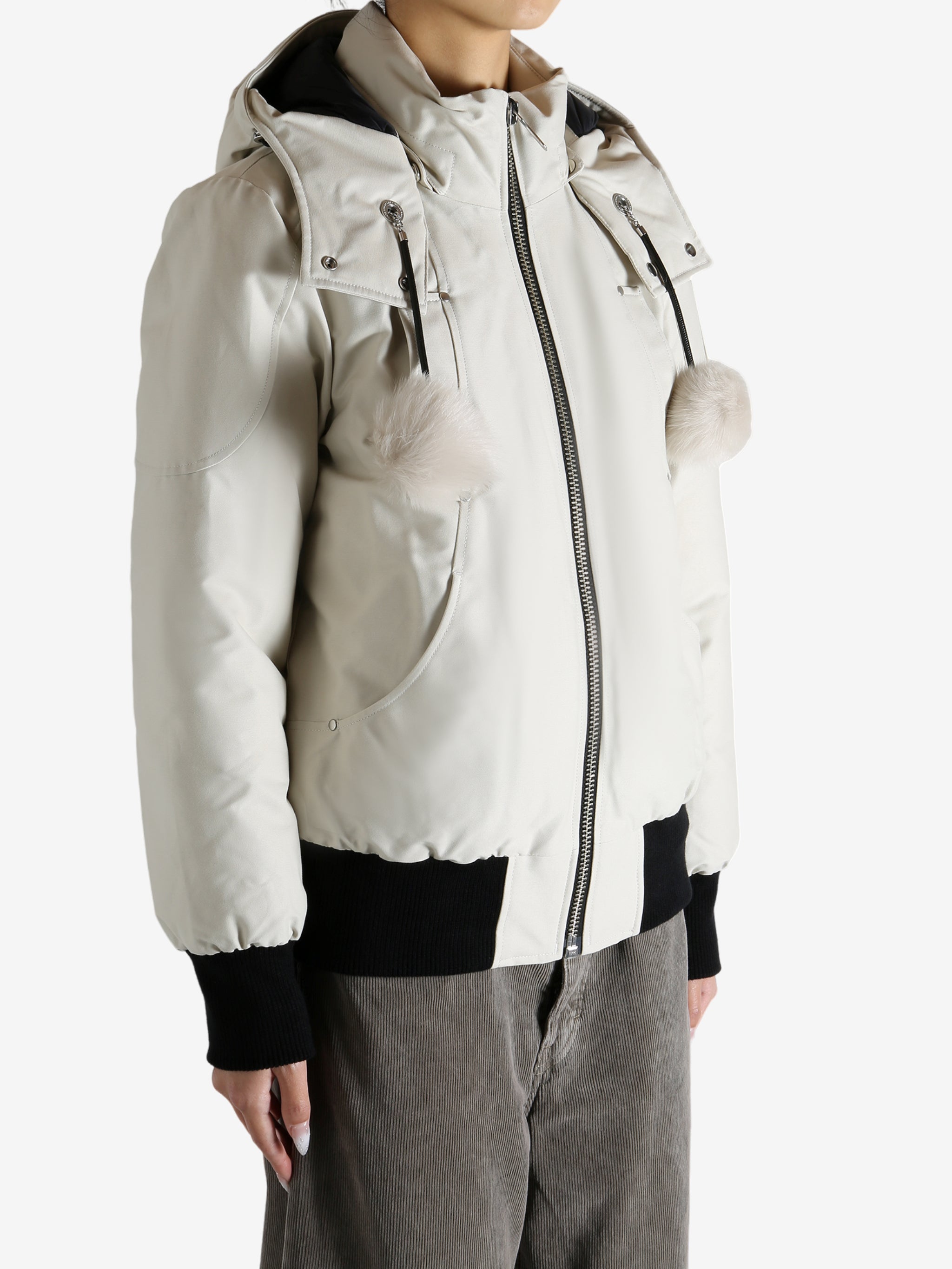 White bomber worn by a person, showing the bomber fit