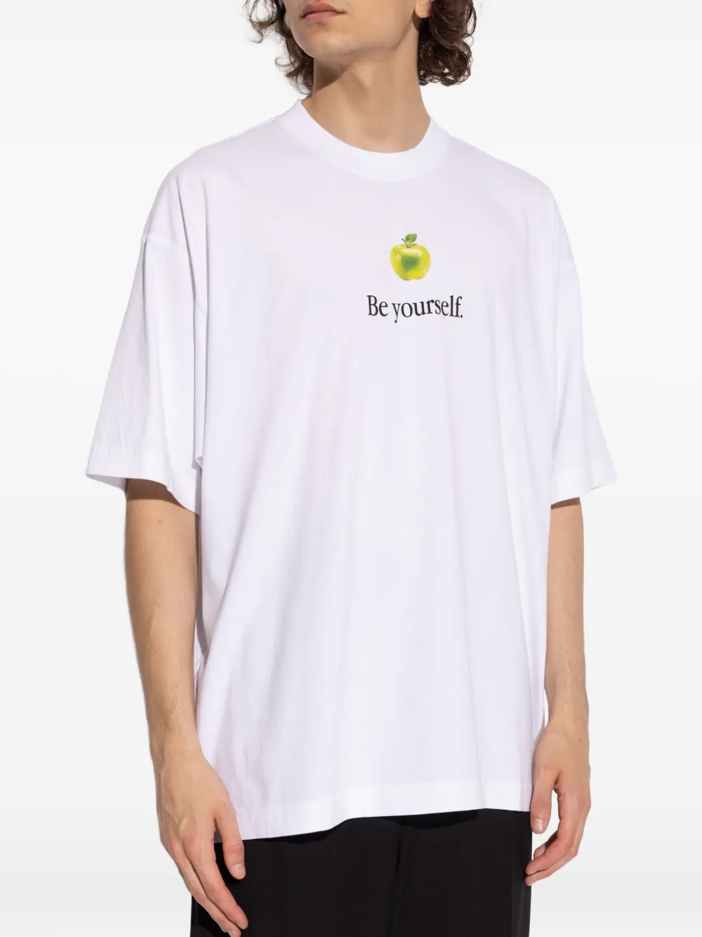 White t-shirt worn by a person, showing the shirt's fit