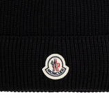 Close up of black hats, showing texture of the cotton fabric