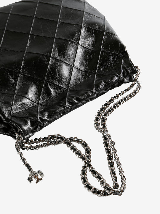 Close up of black bag, showing texture of the leather fabric