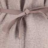 Close up of Tan jacket, showing texture of the 100% wool fabric