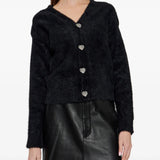 Black knitwear worn by a person, showing the knitwear fit