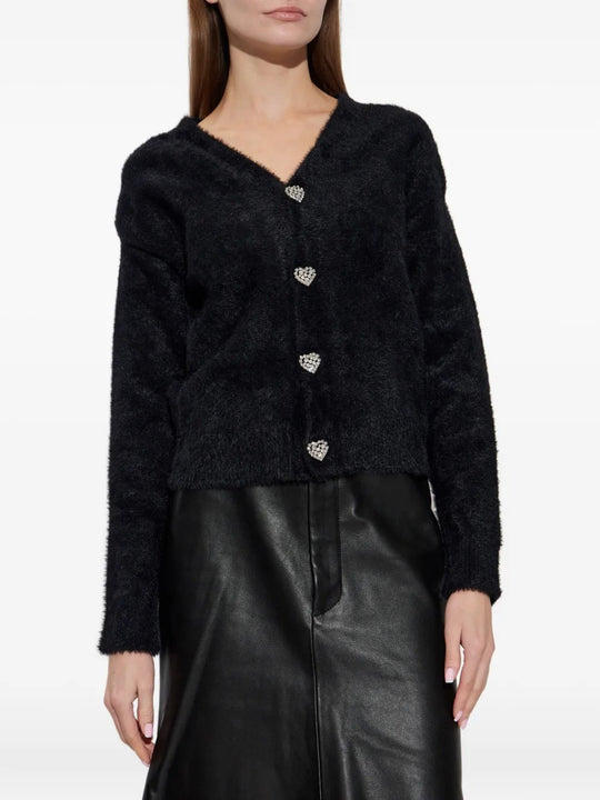 Black knitwear worn by a person, showing the knitwear fit