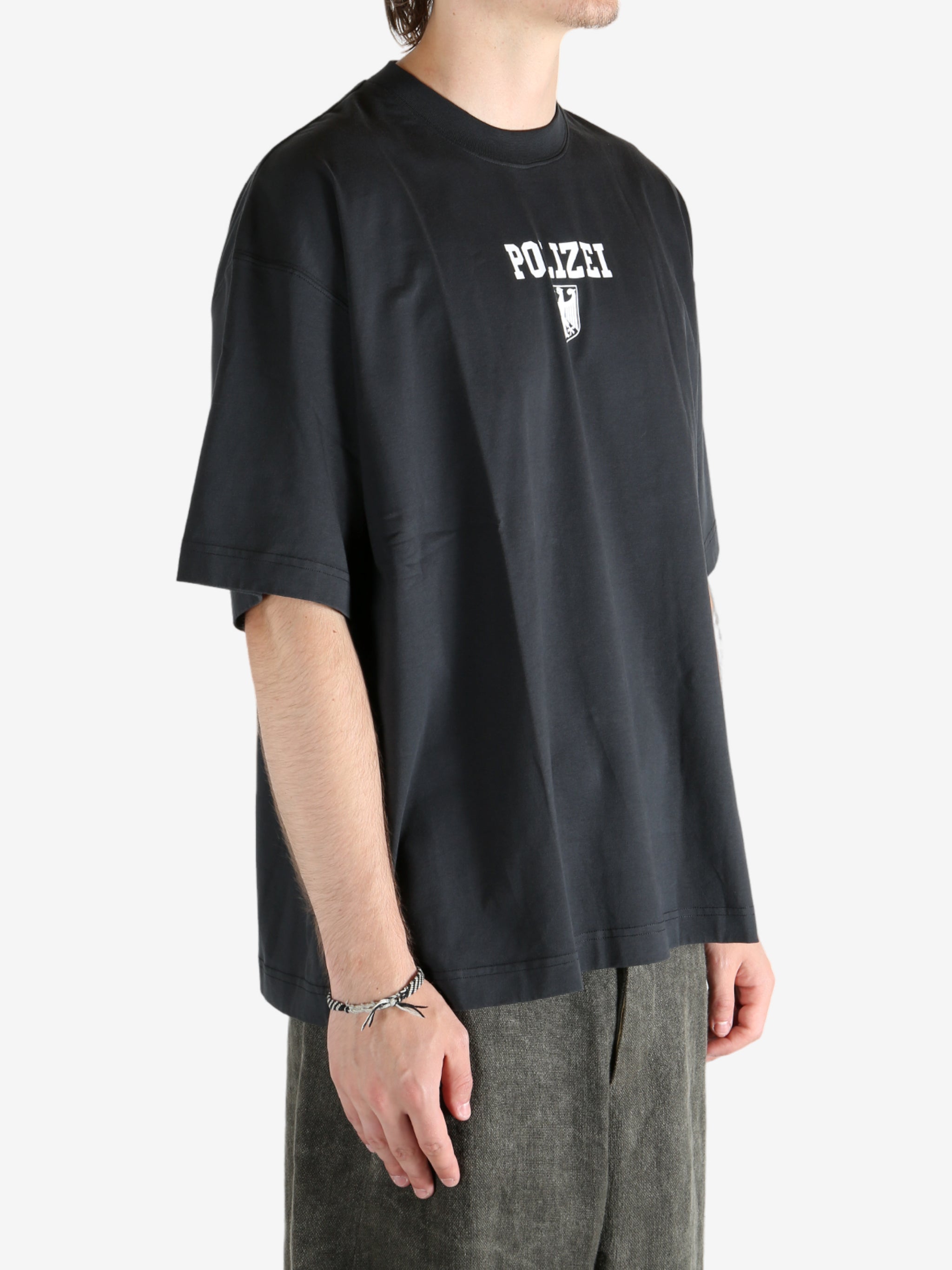 Black shirt worn by a person, showing the shirt's fit