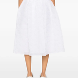 white skirt worn by a person, showing the skirt  fit