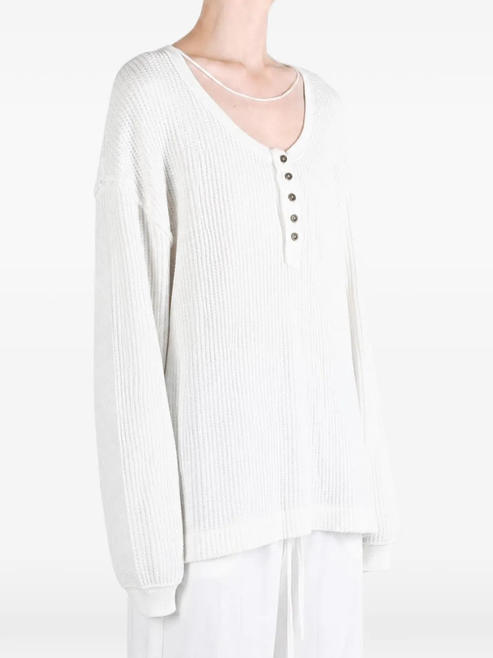 White top worn by a person, showing the top fit