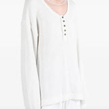 White top worn by a person, showing the top fit