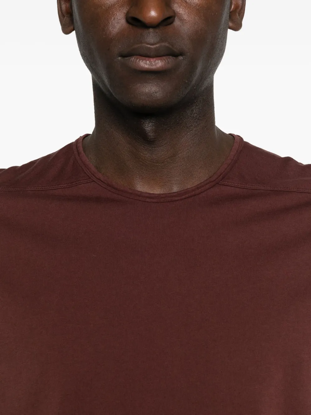 Close up of the red t-shirt, showing texture of the cotton fabric