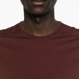 Close up of the red t-shirt, showing texture of the cotton fabric