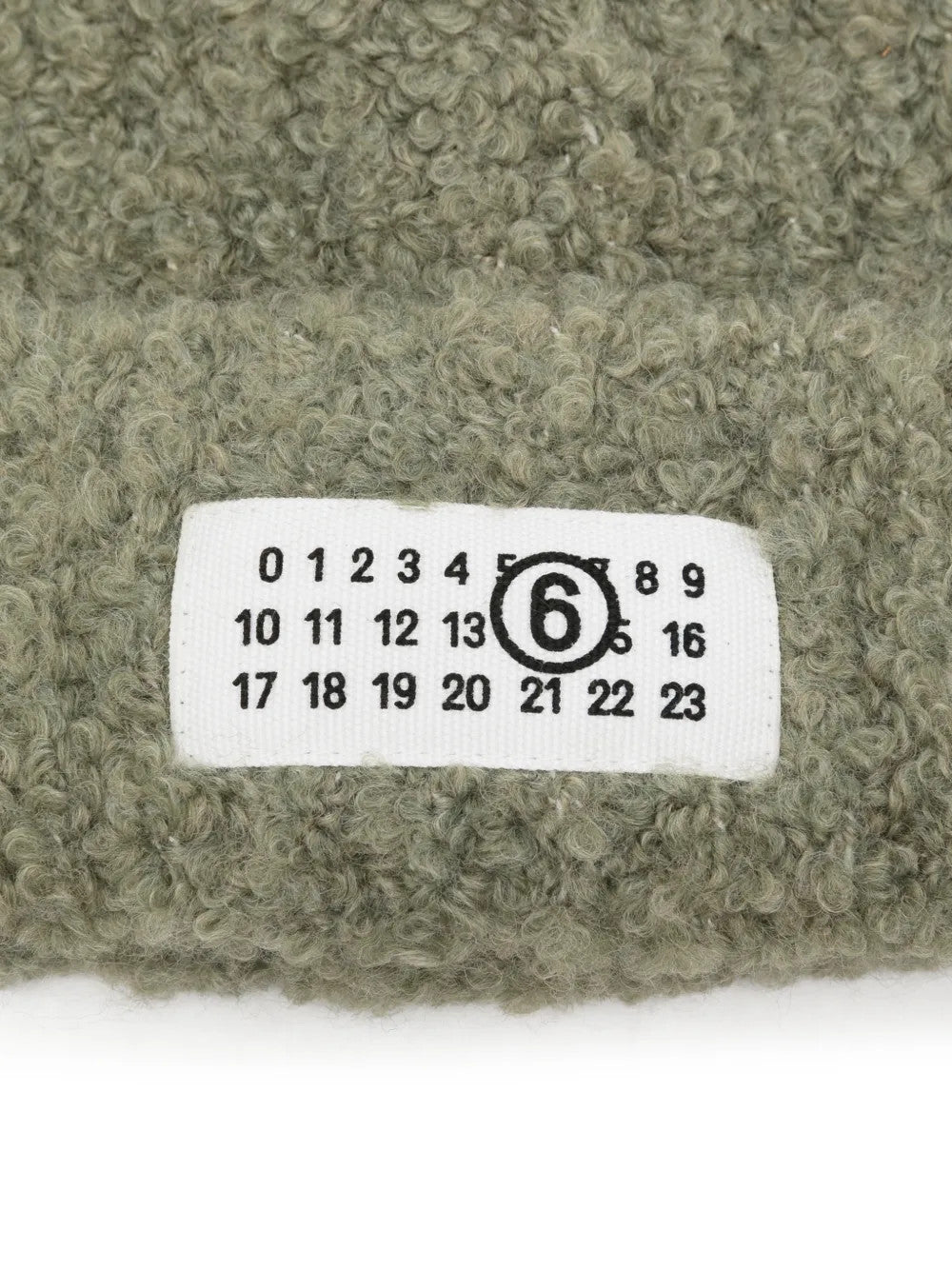 Close up of Green hat, showing texture of the 65% acrylic/ 17% polyamide/ 9% viscose/ 9% wool fabric