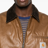 Close up of brown jackets, showing texture of the cotton and nylon fabric