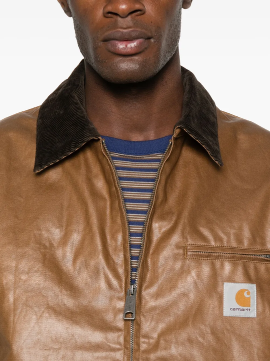 Close up of brown jackets, showing texture of the cotton and nylon fabric