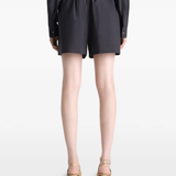Black short worn by a person, showing the short's fit