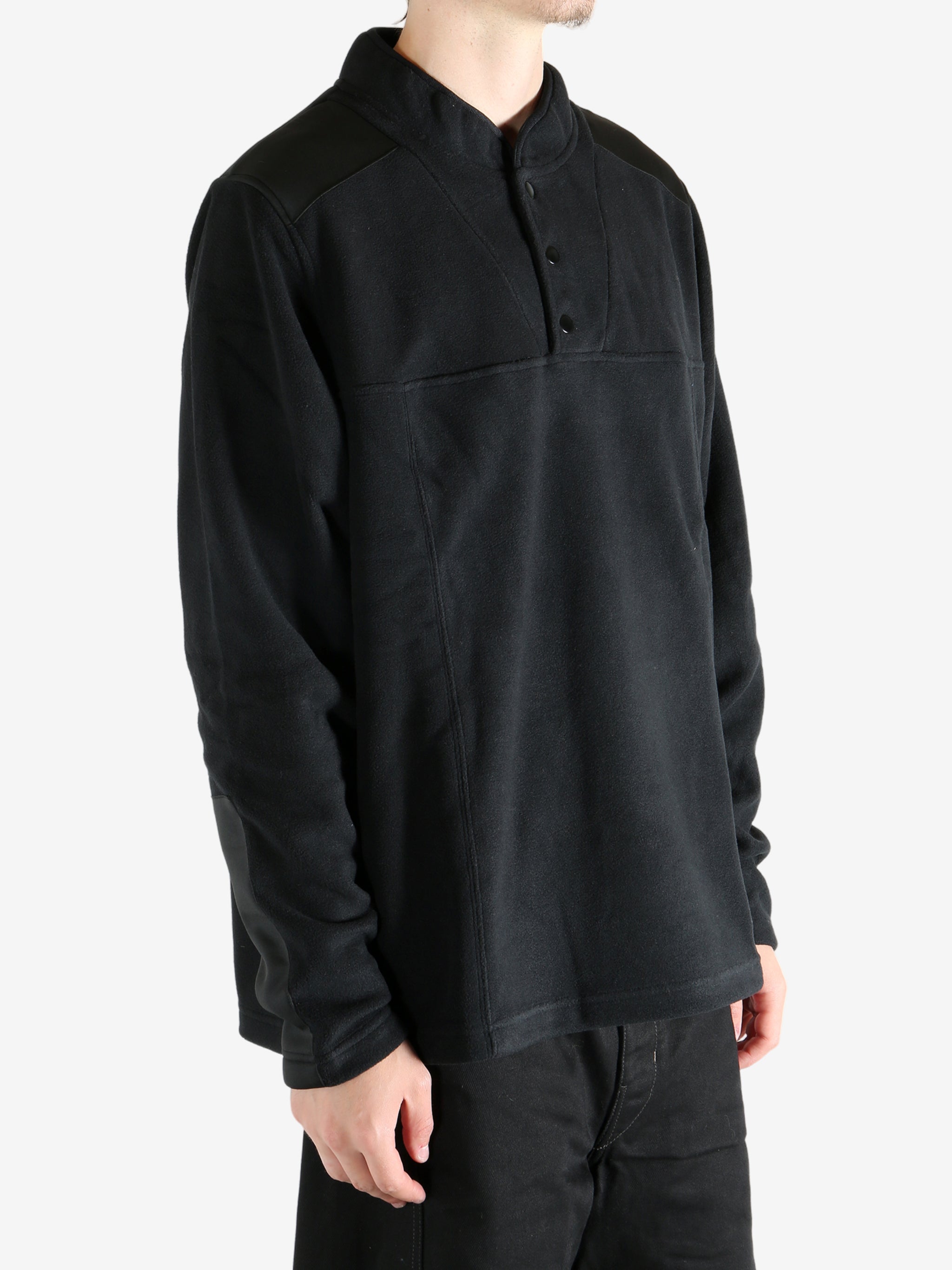 Black sweatshirt worn by a person, showing the sweatshirt's fit