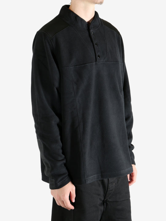 Black sweatshirt worn by a person, showing the sweatshirt's fit