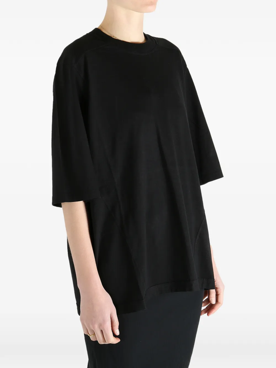 Black t-shirt worn by a person, showing the fit