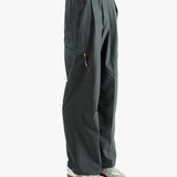 Black pants worn by a person, showing the pants's fit