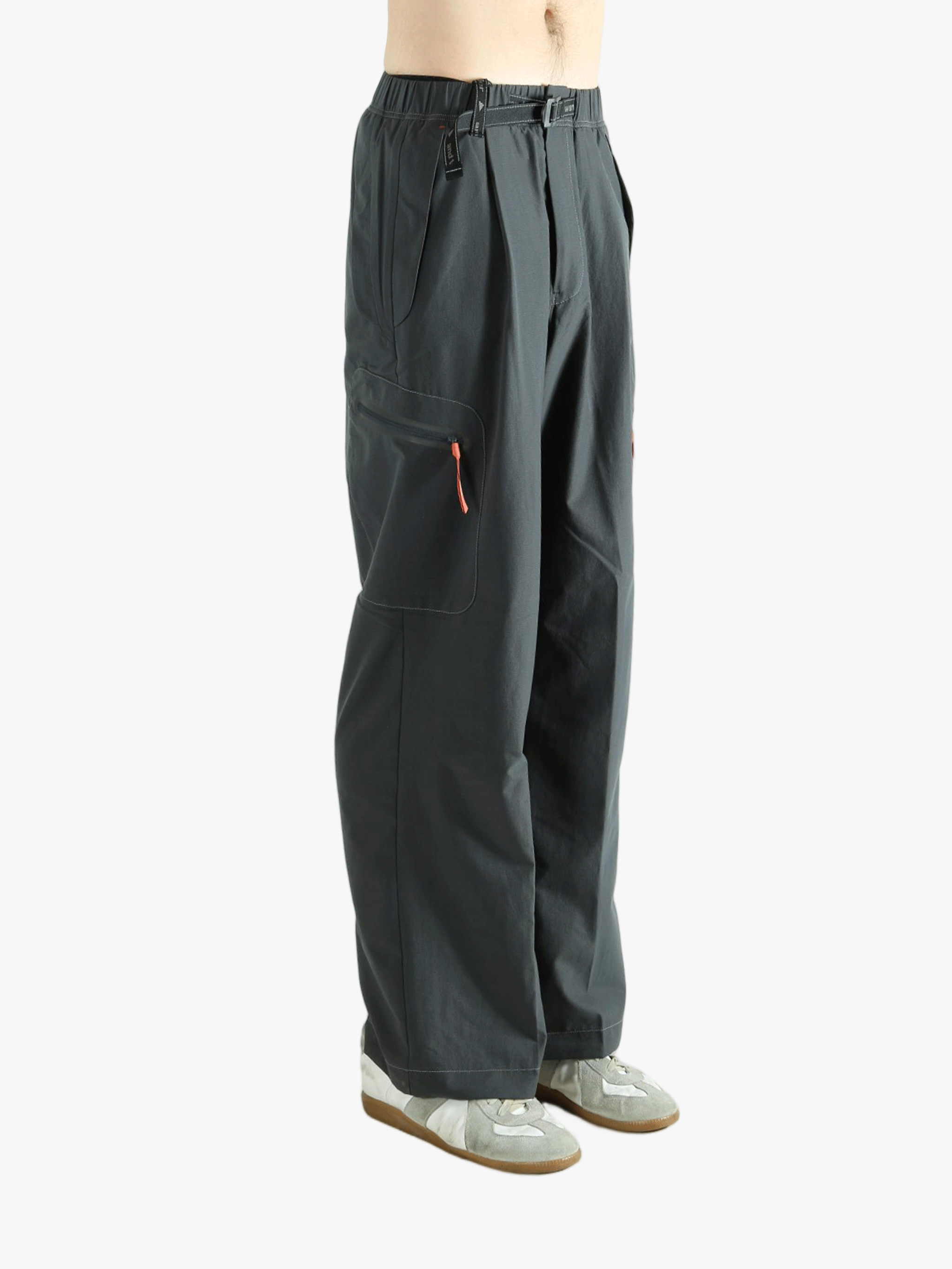 Black pants worn by a person, showing the pants's fit