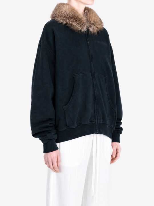 Navy hoodie worn by a person, showing the hoodie fit