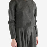 Grey tops worn by a person, showing the tops fit