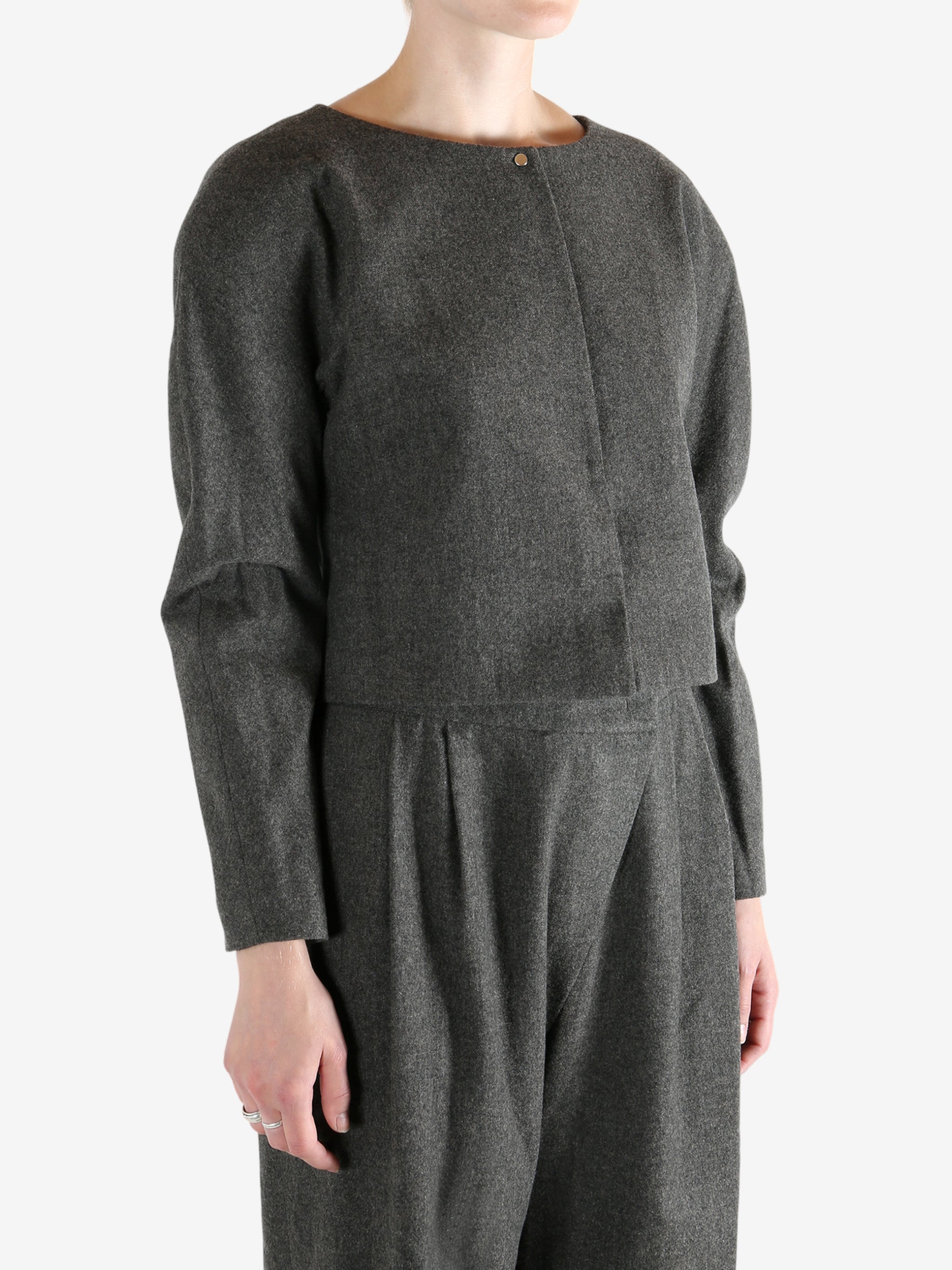 Grey tops worn by a person, showing the tops fit