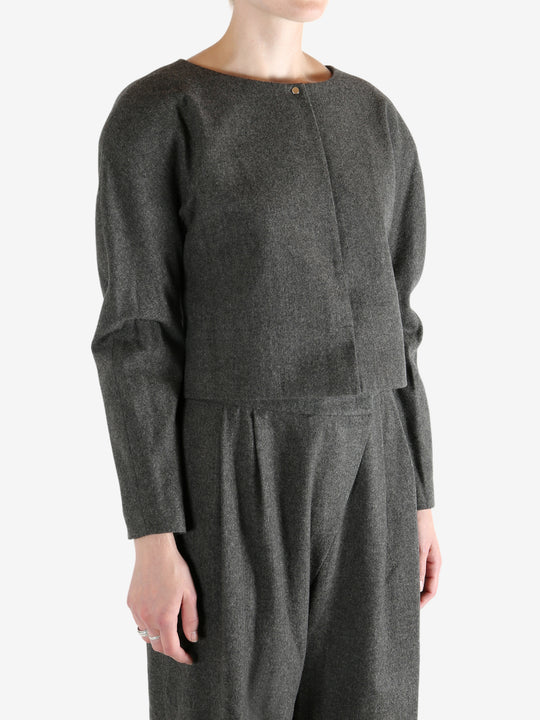 Grey tops worn by a person, showing the tops fit