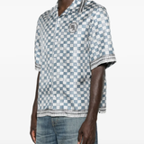 Blue shirt worn by a person, showing the shirt's fit