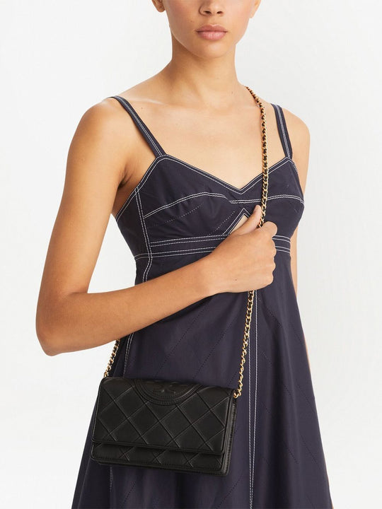 Black bag carried by a person, showing the bag’s fit