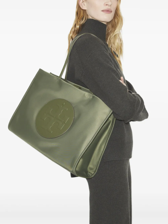 green bag worn by a person, showing the bag fit