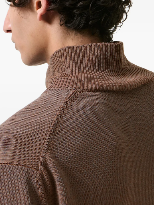 Close up of brown sweater, showing texture of the Cotton fabric