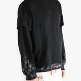 Black t-shirts worn by a person, showing the t-shirts fit