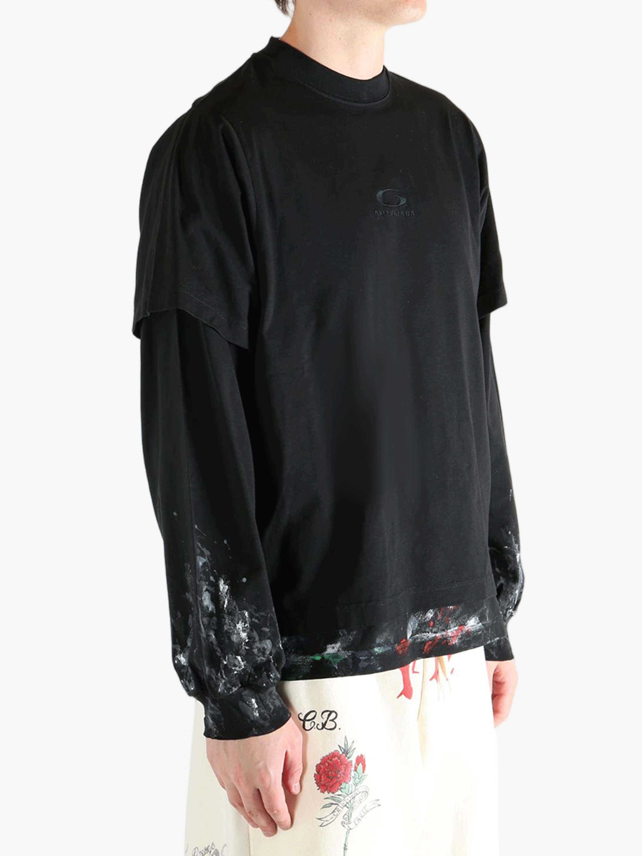 Black t-shirts worn by a person, showing the t-shirts fit