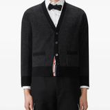 Black knitwear worn by a person, showing the knitwear fit