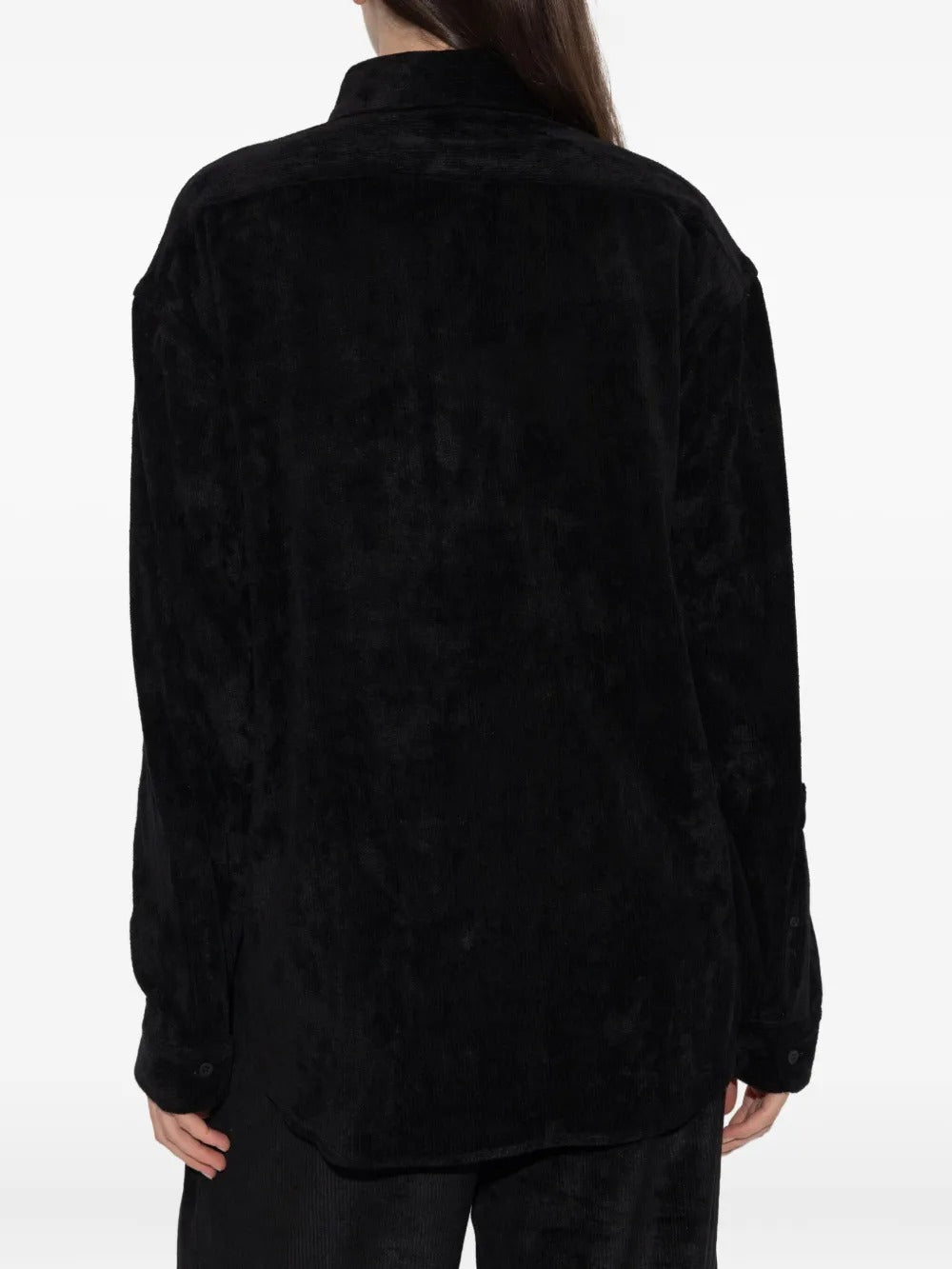 Black shirt worn by a person, showing the shirt's fit