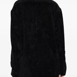 Black shirt worn by a person, showing the shirt's fit